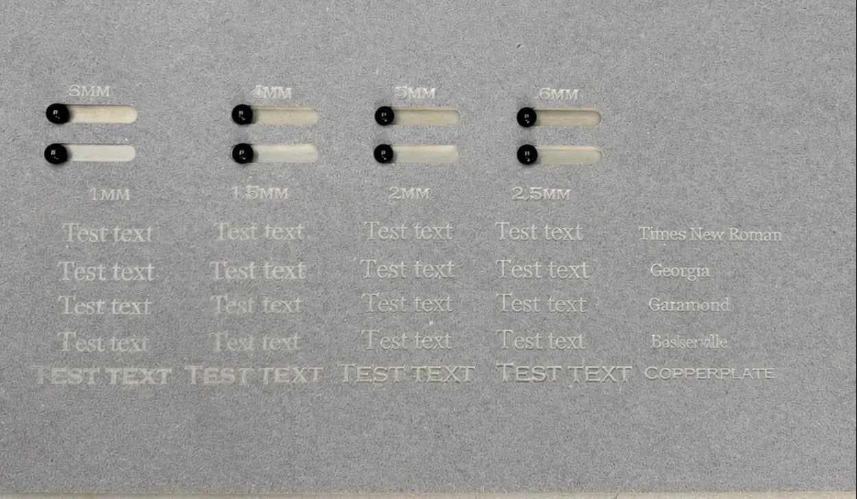 Complete MDF settings-test board with engraved text, depth labels, routed slots and fitted black pieces