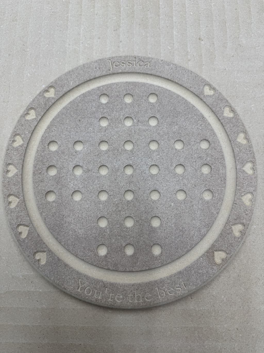 Circular CNC-machined solitaire board with pockets, engraved wording and heart details